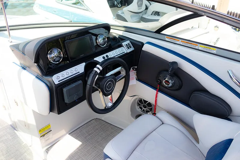 Slide: The Image of 2022 Crownline E 255 XS boat cockpit with modern steering and controls. - 10