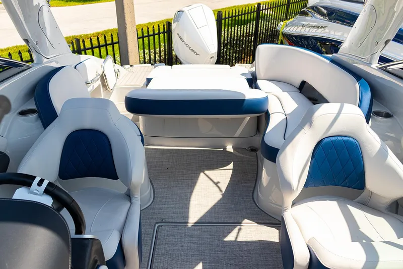 Slide: The Image of 2022 Crownline E 255 XS boat interior with blue and white seating. - 14