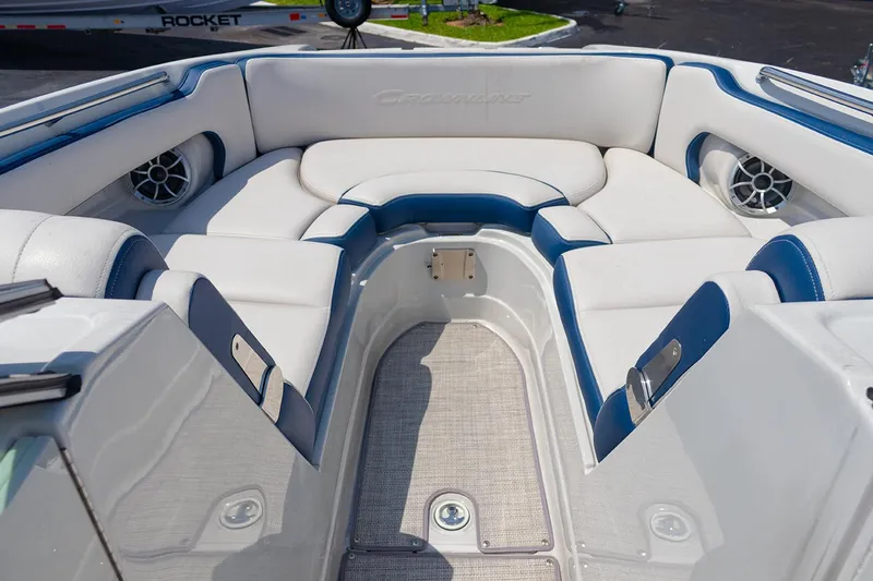 Slide: The Image of 2022 Crownline E 255 XS boat interior with white and blue seating. - 3
