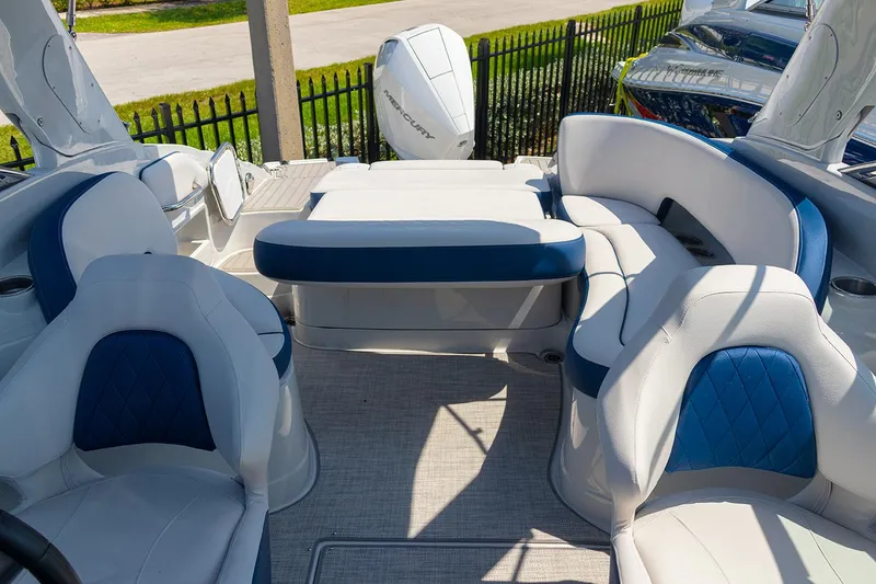 Slide: The Image of 2022 Crownline E 255 XS boat interior with white and blue seating. - 15