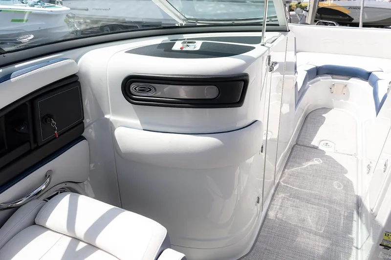 Slide: The Image of 2022 Crownline E 255 XS boat interior with sleek white seating and modern dashboard. - 17