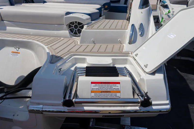 Slide: The Image of 2022 Crownline E 255 XS boat with swim platform and ladder. - 24