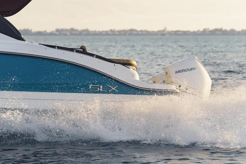 Slide: The Image of 2024 Sea Ray SLX 280 Outboard cruising on water, showcasing sleek design and powerful engine. - 21