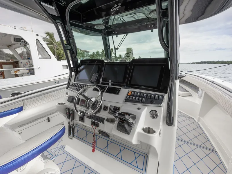 Slide: The Image of 2014 Hydra-Sports 42 Custom Siesta boat cockpit with advanced navigation controls and sleek design. - 18