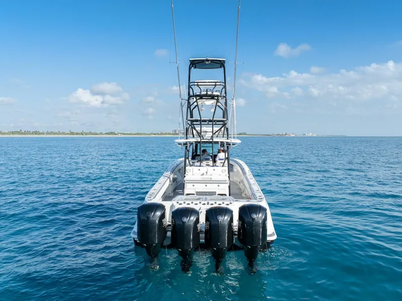 Slide: The Image of 2014 Hydra-Sports 42 Custom Siesta boat with four engines on open water. - 11