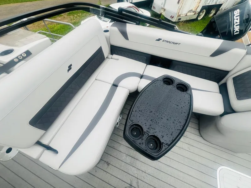 Slide: The Image of Luxurious seating area on 2025 Starcraft CX 23 DL BAR boat with sleek design and table. - 10