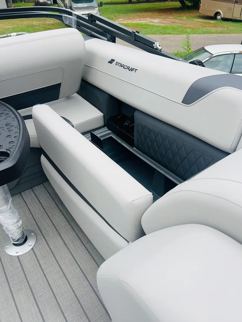 Slide: The Image of 2025 Starcraft CX 23 DL BAR boat interior with luxurious seating and storage compartments. - 12