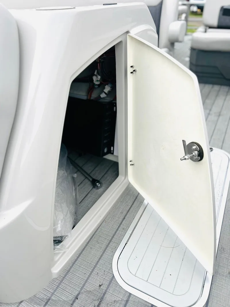 Slide: The Image of Open storage compartment on 2025 Starcraft CX 23 DL BAR boat. - 4
