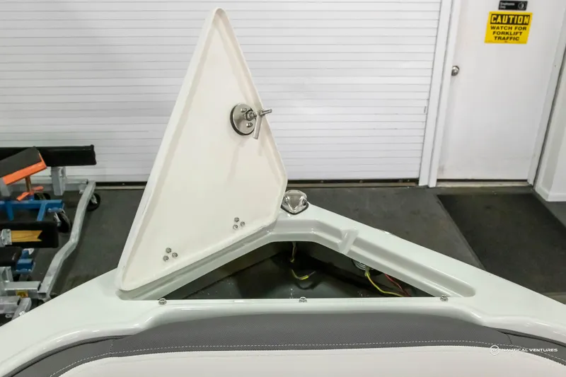 Slide: The Image of Open storage compartment on 2023 Crownline 260 XSS boat. - 13