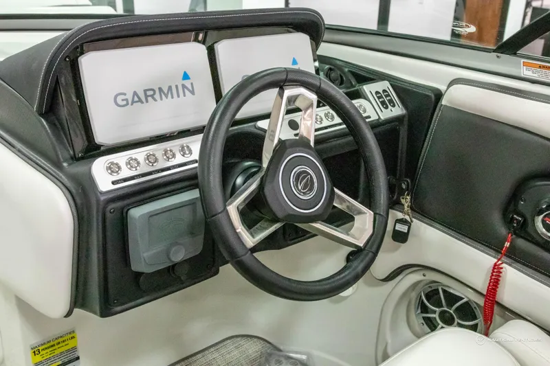 Slide: The Image of 2023 Crownline 260 XSS boat dashboard with Garmin navigation system and steering wheel. - 18