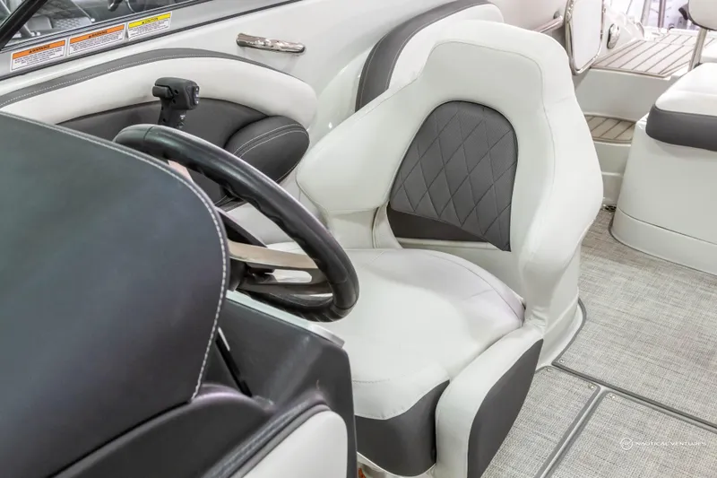 Slide: The Image of 2023 Crownline 260 XSS boat interior with plush seating and modern steering wheel. - 22
