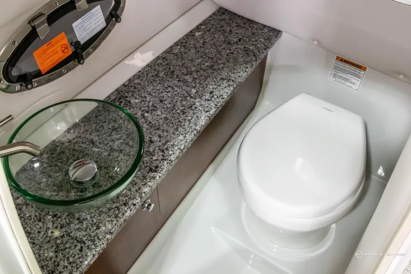Slide: The Image of 2023 Crownline 260 XSS boat bathroom with granite countertop and modern fixtures. - 27