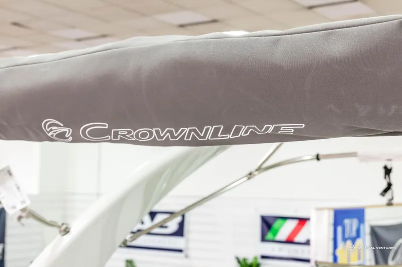Slide: The Image of 2023 Crownline 260 XSS boat detail with logo in showroom. - 34