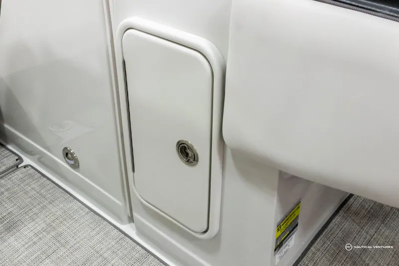 Slide: The Image of 2023 Crownline 260 XSS boat interior storage compartment. - 36