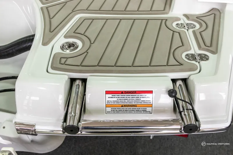 Slide: The Image of Crownline 260 XSS 2023 swim platform with safety warning label and stainless steel ladder. - 39
