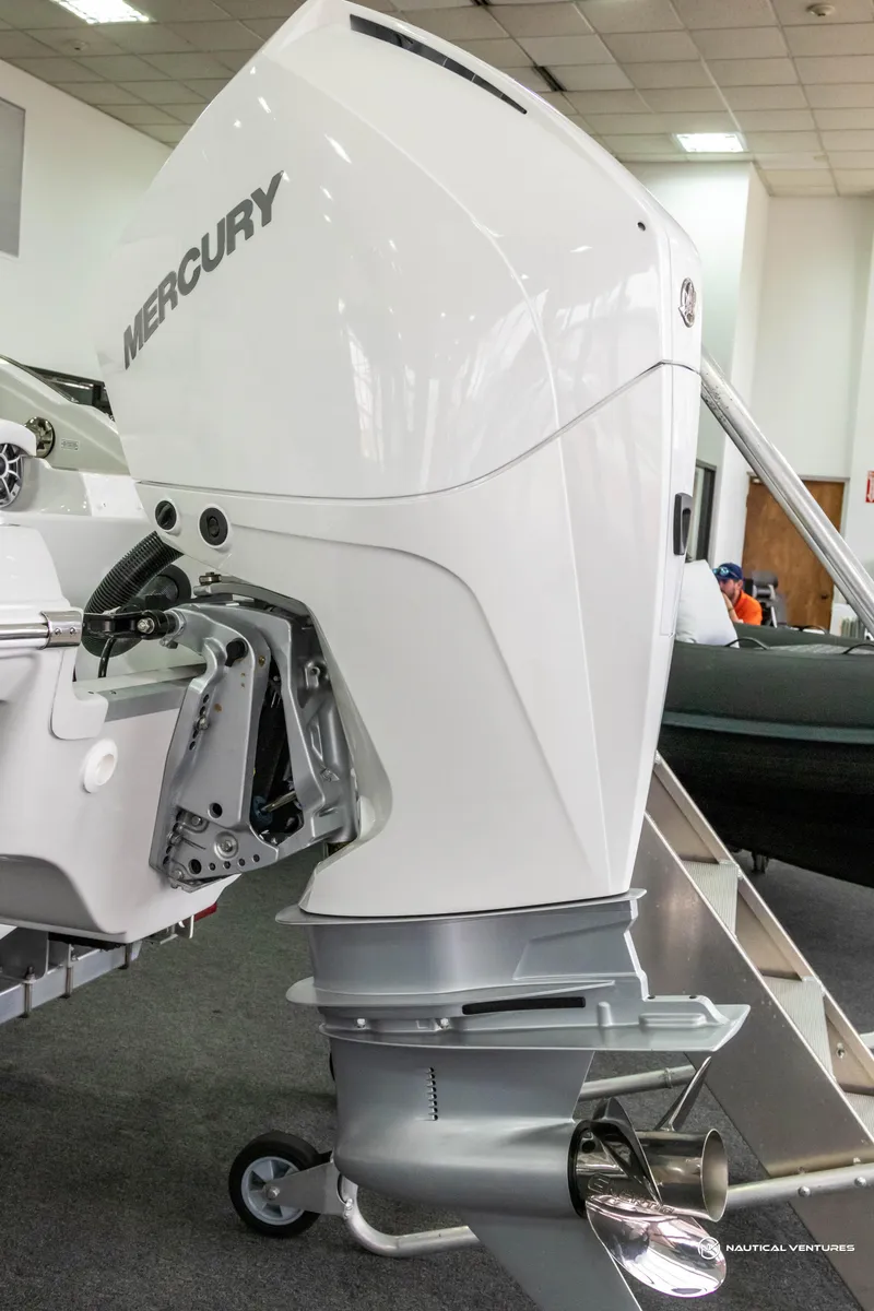 Slide: The Image of 2023 Crownline 260 XSS with Mercury outboard motor in showroom. - 41