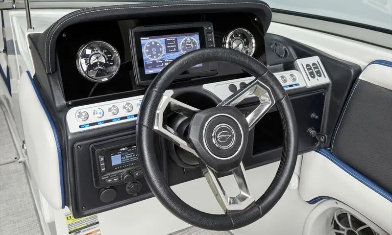 Slide: The Image of 2023 Crownline 260 XSS dashboard with modern steering wheel and digital display. - 43