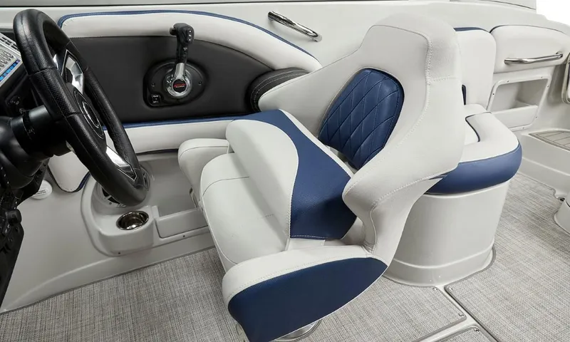 Slide: The Image of 2023 Crownline 260 XSS boat interior with blue and white seating and steering wheel. - 46