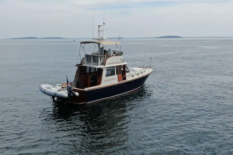 Slide: The Image of 1997 Lyman-Morse Custom Flybridge yacht on calm ocean waters. - 0