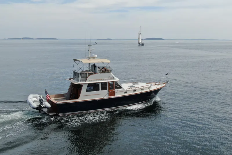 Slide: The Image of 1997 Lyman-Morse Custom Flybridge yacht cruising on calm ocean waters. - 1