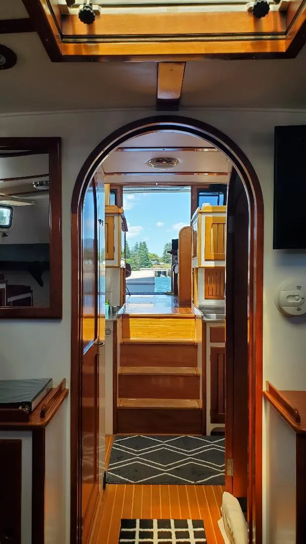 Slide: The Image of Interior view of 1997 Lyman-Morse Custom Flybridge yacht with wooden finishes and open hatch. - 12