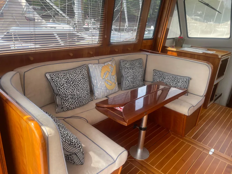 Slide: The Image of 1997 Lyman-Morse Custom Flybridge interior with elegant seating and wooden table. - 16