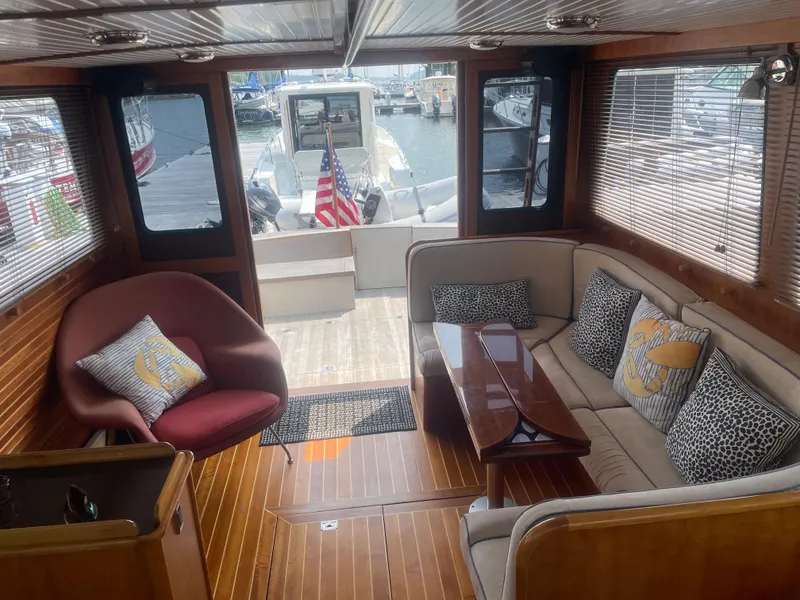 Slide: The Image of Luxurious 1997 Lyman-Morse Custom Flybridge interior with elegant seating and wooden flooring. - 17