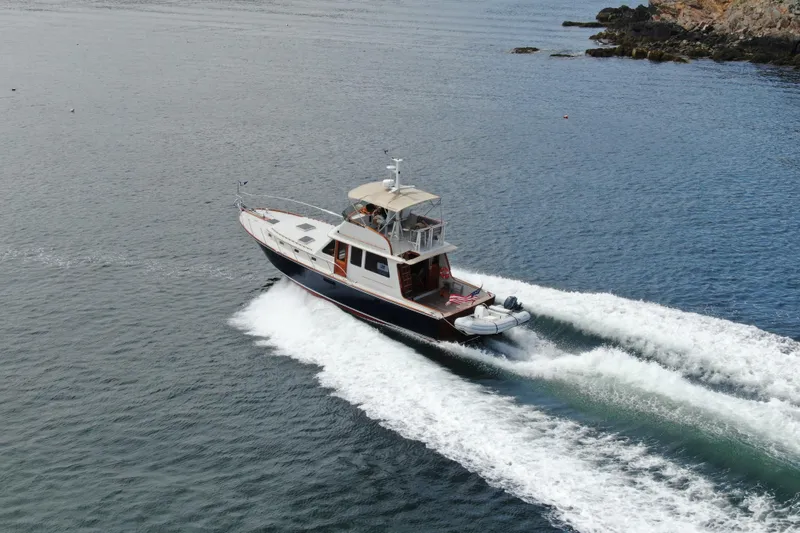 Slide: The Image of 1997 Lyman-Morse Custom Flybridge yacht cruising on open water. - 2