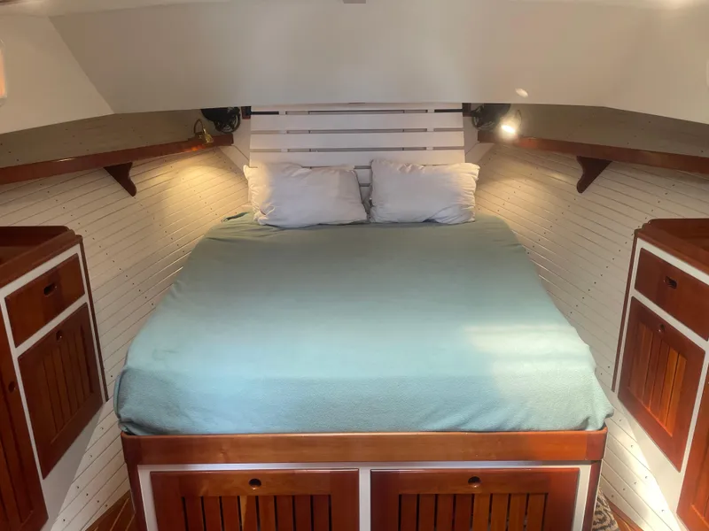 Slide: The Image of Cozy cabin interior of 1997 Lyman-Morse Custom Flybridge with wooden accents and a comfortable bed. - 20