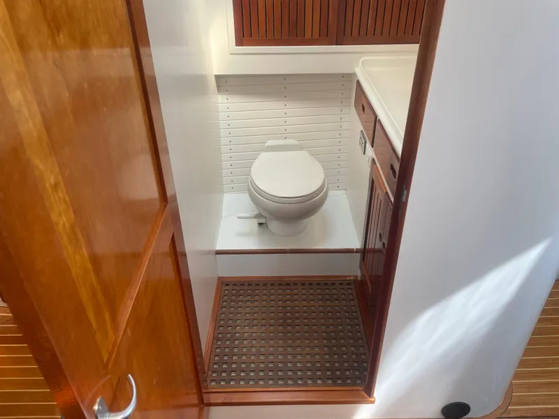 Slide: The Image of 1997 Lyman-Morse Custom Flybridge yacht bathroom with wooden accents and modern fixtures. - 25