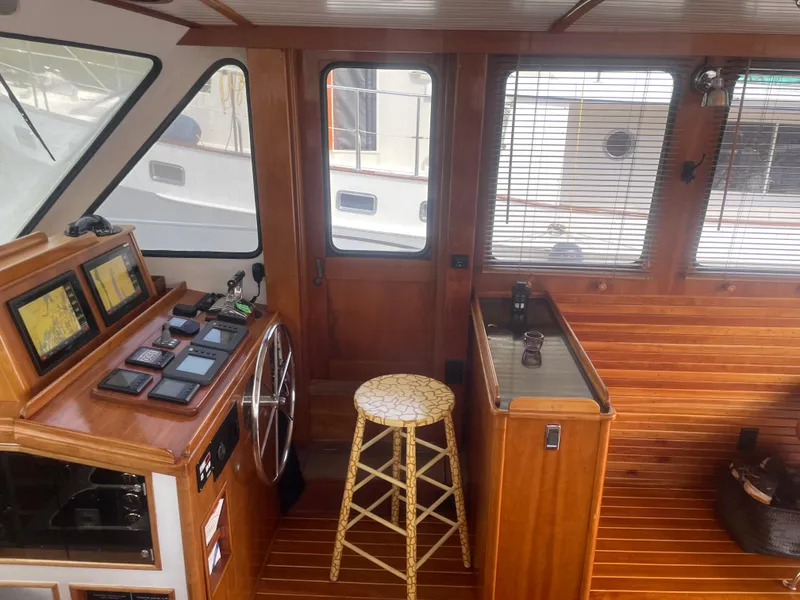 Slide: The Image of Interior of 1997 Lyman-Morse Custom Flybridge with wooden paneling and navigation equipment. - 27