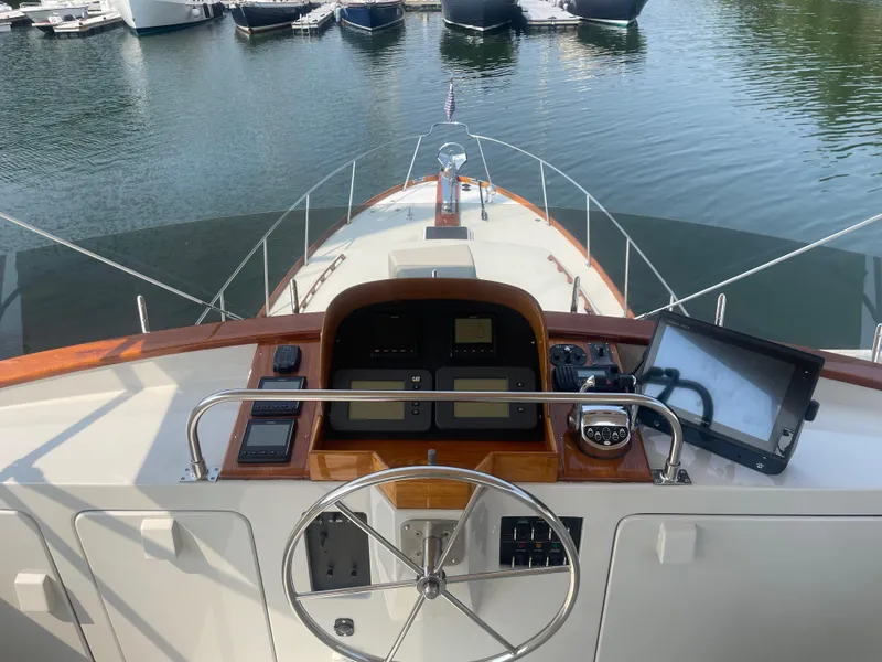 Slide: The Image of Flybridge helm of 1997 Lyman-Morse Custom yacht with steering wheel and navigation equipment. - 30