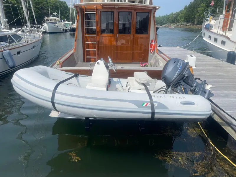 Slide: The Image of 1997 Lyman-Morse Custom Flybridge with inflatable dinghy docked in a marina. - 31