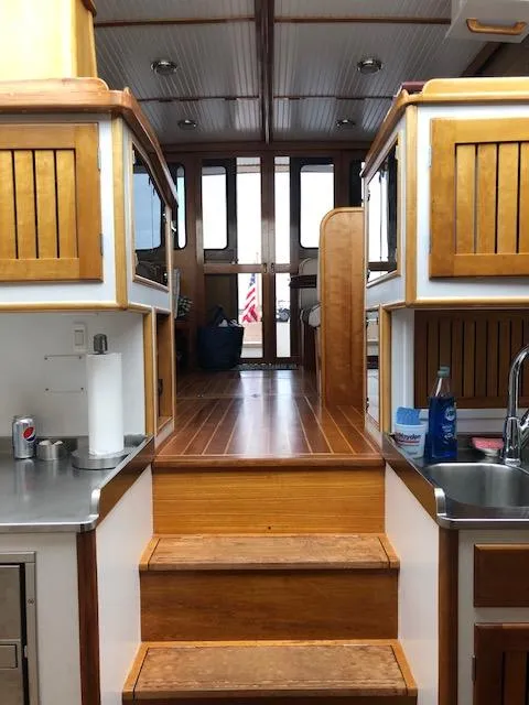 Slide: The Image of Interior of 1997 Lyman-Morse Custom Flybridge with wooden cabinetry and stainless steel sink. - 34
