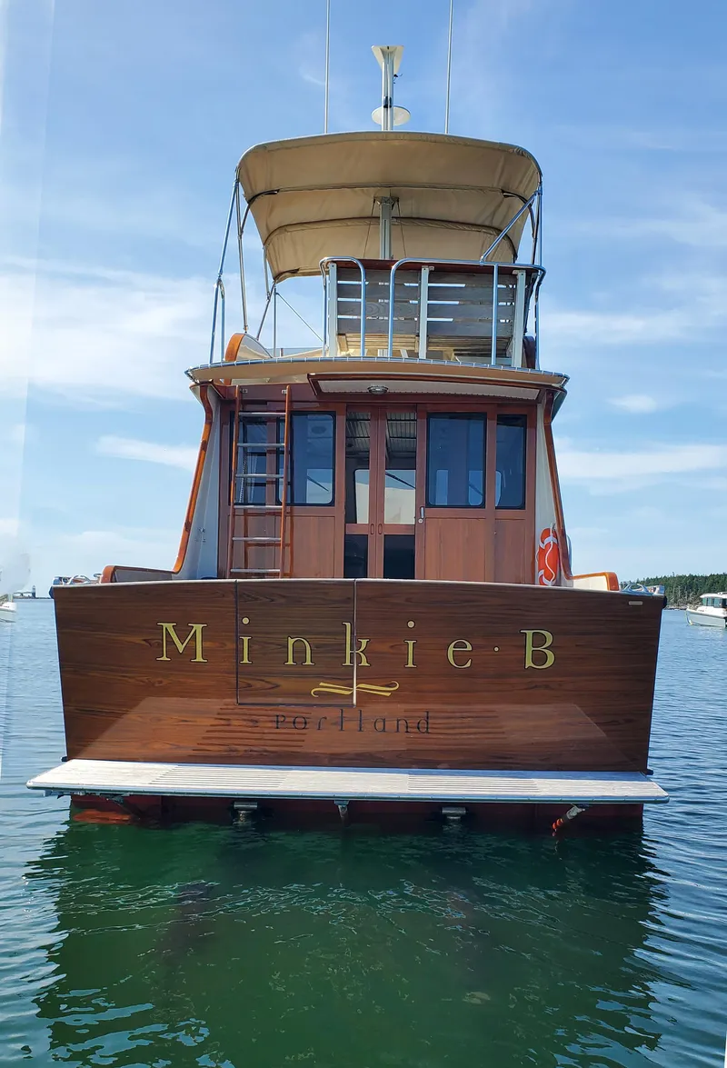 Slide: The Image of 1997 Lyman-Morse Custom Flybridge yacht on water, rear view, clear sky. - 8
