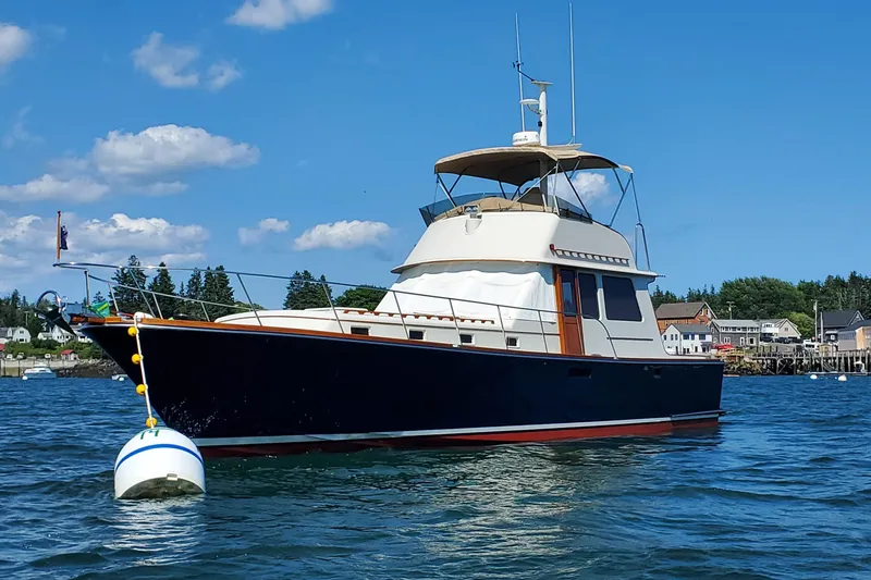 Slide: The Image of 1997 Lyman-Morse Custom Flybridge yacht on calm water, clear blue sky background. - 9