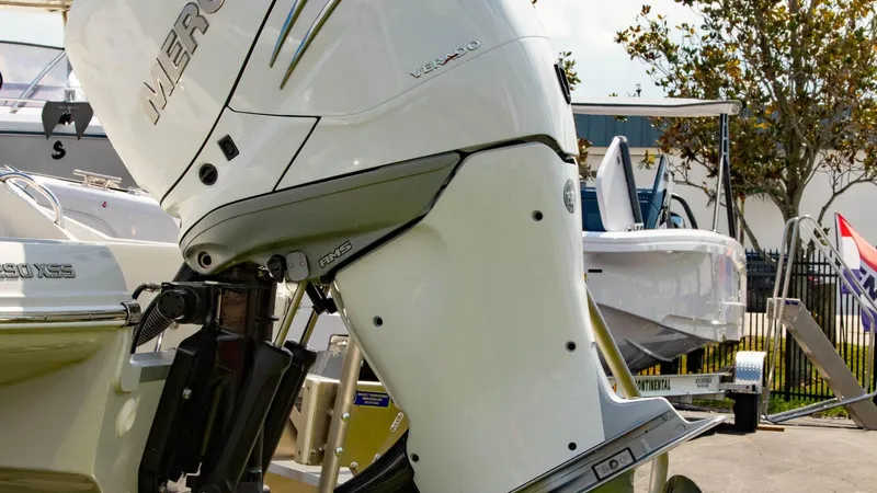 Slide: The Image of Close-up of 2023 Crownline 290 XSS boat engine in a marina setting. - 28