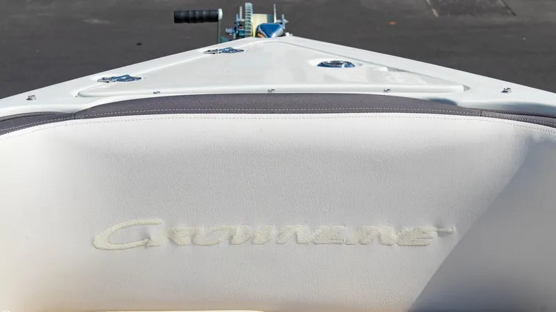 Slide: The Image of Crownline 290 XSS 2023 boat bow with logo, white upholstery, and sleek design. - 6
