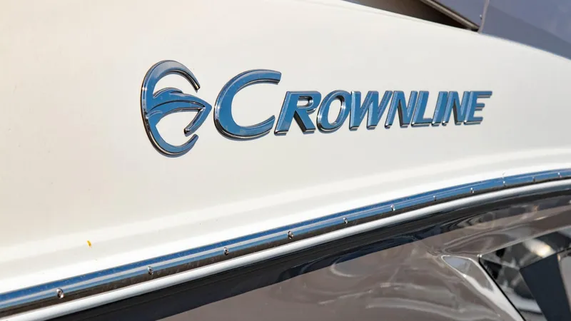 Slide: The Image of Crownline 290 XSS 2023 boat logo on white hull. - 18