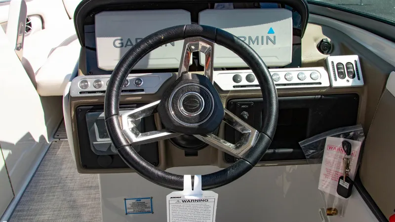 Slide: The Image of Steering wheel of 2023 Crownline 290 XSS boat with Garmin navigation system. - 11