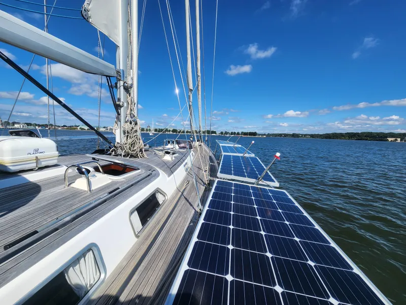 Slide: The Image of Hallberg-Rassy 62 sailboat with solar panels on deck, sailing on a sunny day, 2008 model. - 12