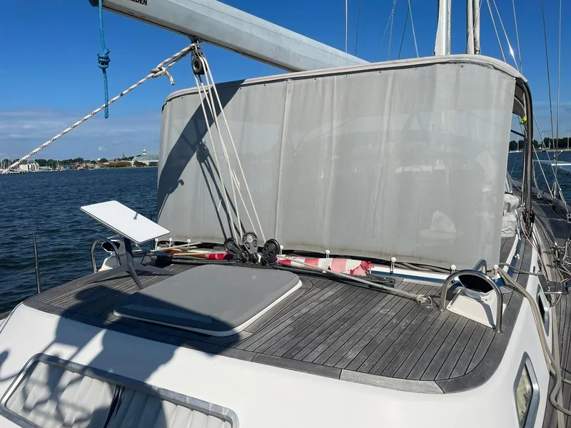 Slide: The Image of 2008 Hallberg-Rassy 62 yacht deck with sunshade, moored by the water. - 15
