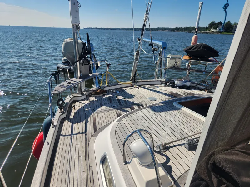 Slide: The Image of Deck view of a 2008 Hallberg-Rassy 62 sailboat on calm waters. - 16
