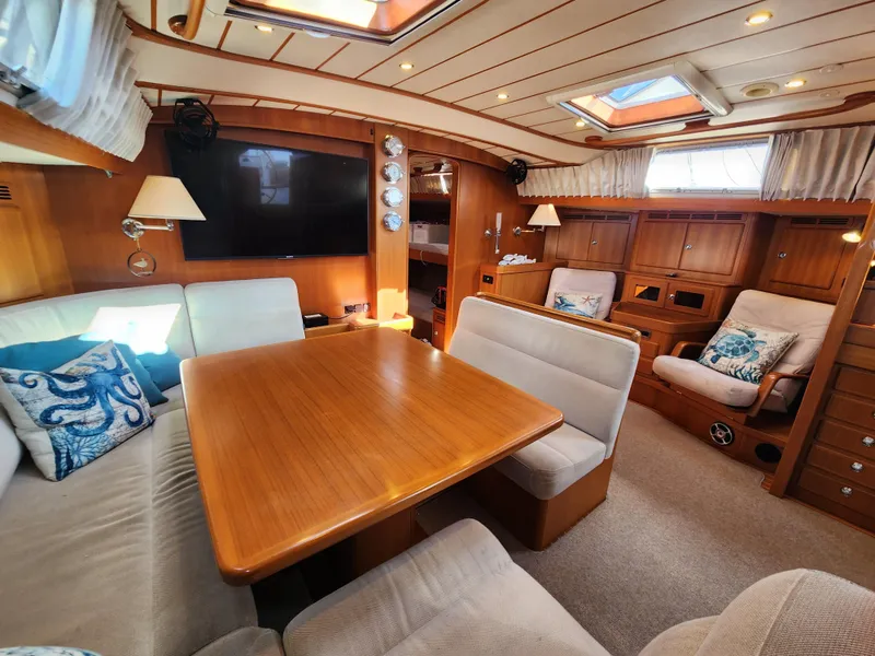 Slide: The Image of Luxurious interior of a 2008 Hallberg-Rassy 62 yacht with elegant wood finishes and cozy seating. - 28