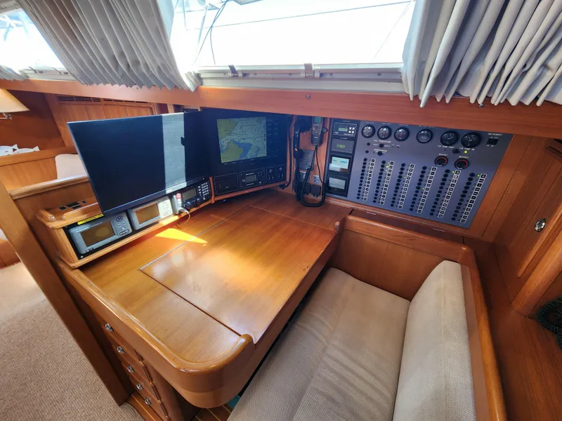 Slide: The Image of Navigation station of 2008 Hallberg-Rassy 62 yacht with control panels and monitors. - 32