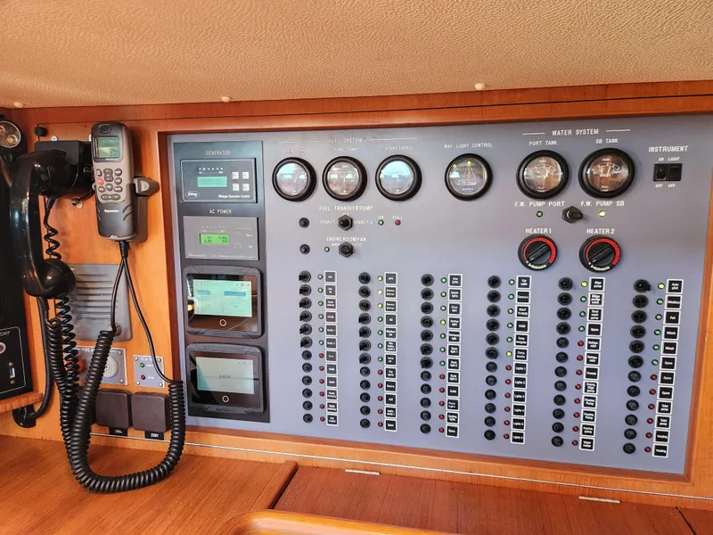 Slide: The Image of Electrical control panel on a 2008 Hallberg-Rassy 62 yacht, featuring gauges and communication devices. - 33