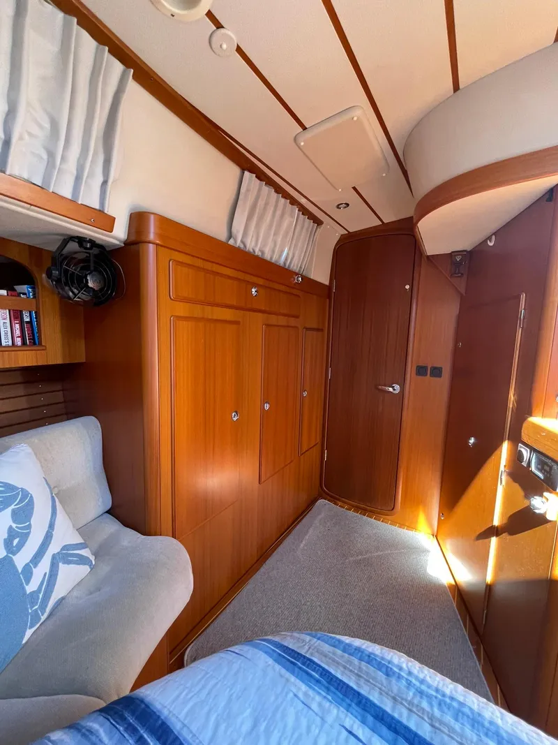 Slide: The Image of Interior of 2008 Hallberg-Rassy 62 yacht with wooden cabinetry and cozy seating. - 43