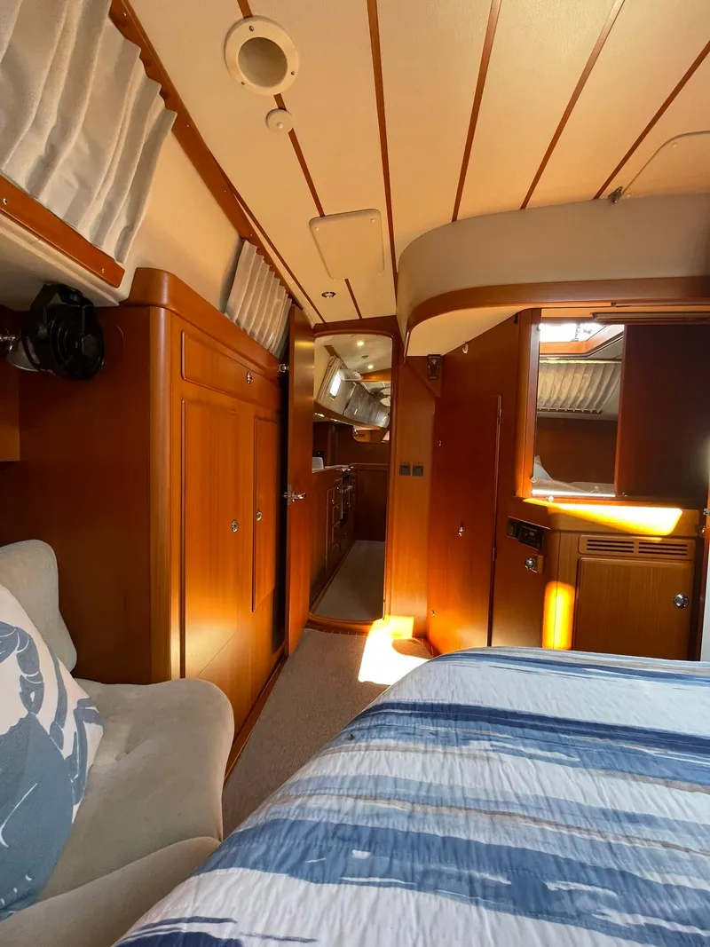 Slide: The Image of Interior of 2008 Hallberg-Rassy 62 yacht with wood finish and cozy furnishings. - 44