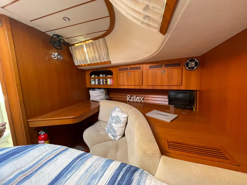 Slide: The Image of Cozy cabin interior of 2008 Hallberg-Rassy 62 yacht with wooden furnishings and seating. - 46