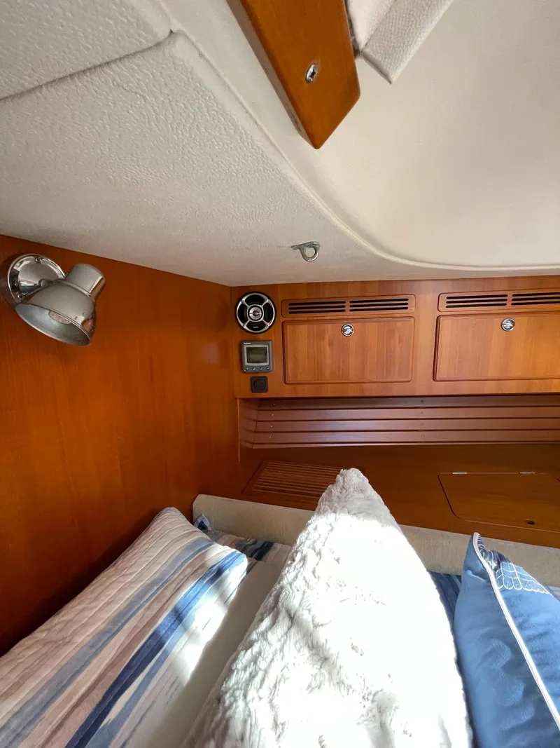 Slide: The Image of Interior cabin of 2008 Hallberg-Rassy 62 yacht with wooden paneling and cozy bedding. - 47